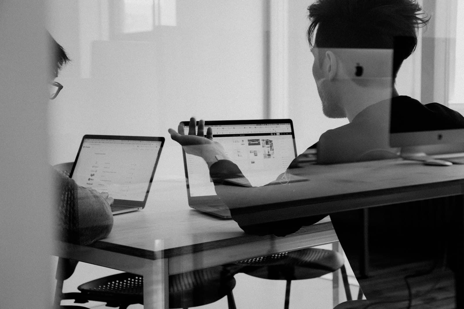 Small business owner managing client intake forms on a laptop at a clean desk